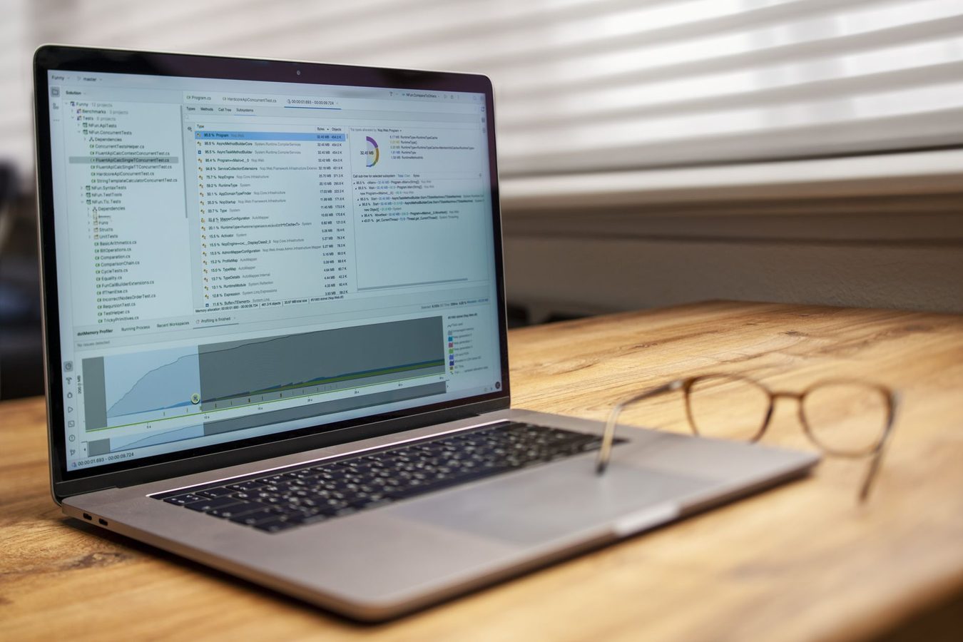 A MacBook on a desk with a terminal window open on screen